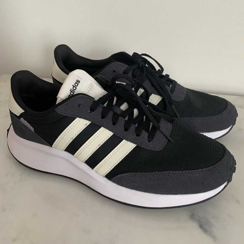 Adidas black with signature stripes. Worn 2 times in almost new condition.